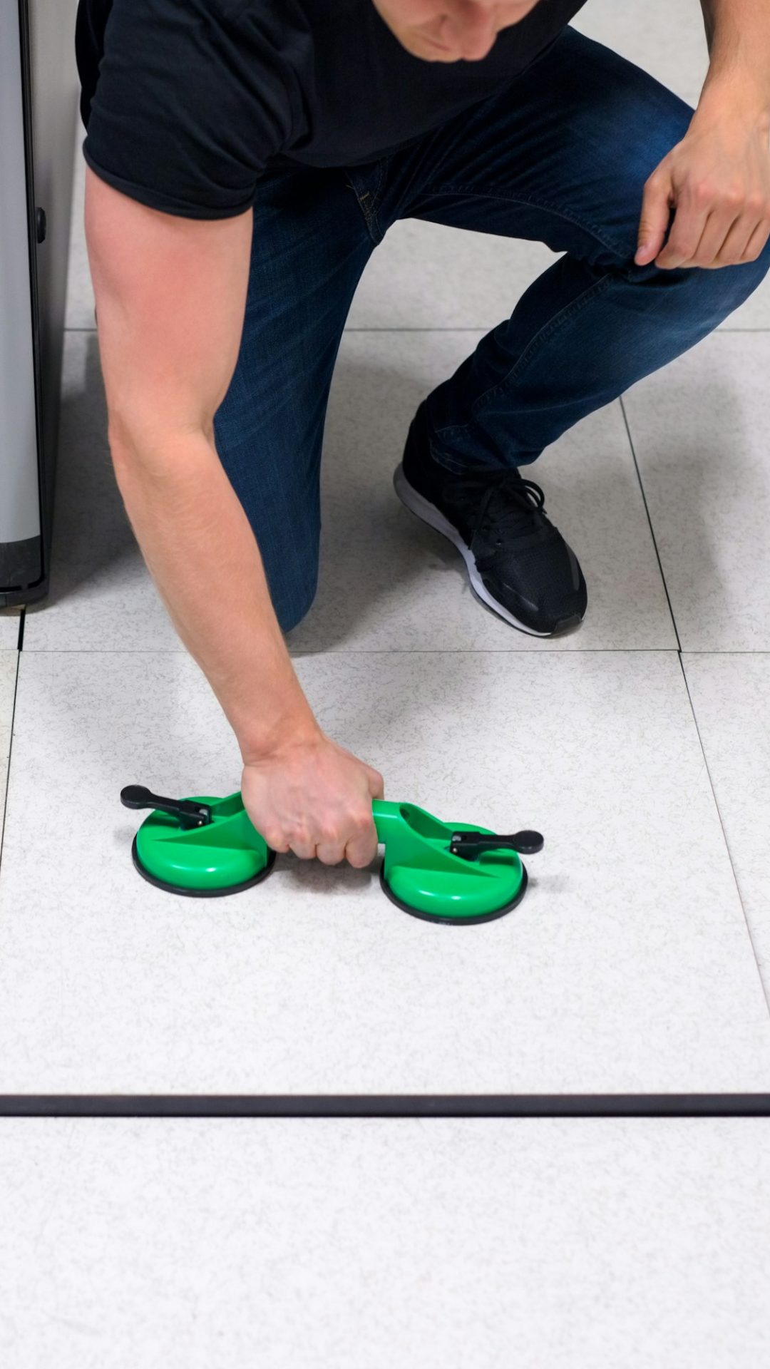 Computer Engineer Pulling Floor Tile Using Suction Cups In Datac